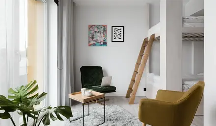 a room with a bunk bed and a chair