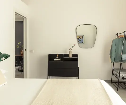 a mirror above a bed