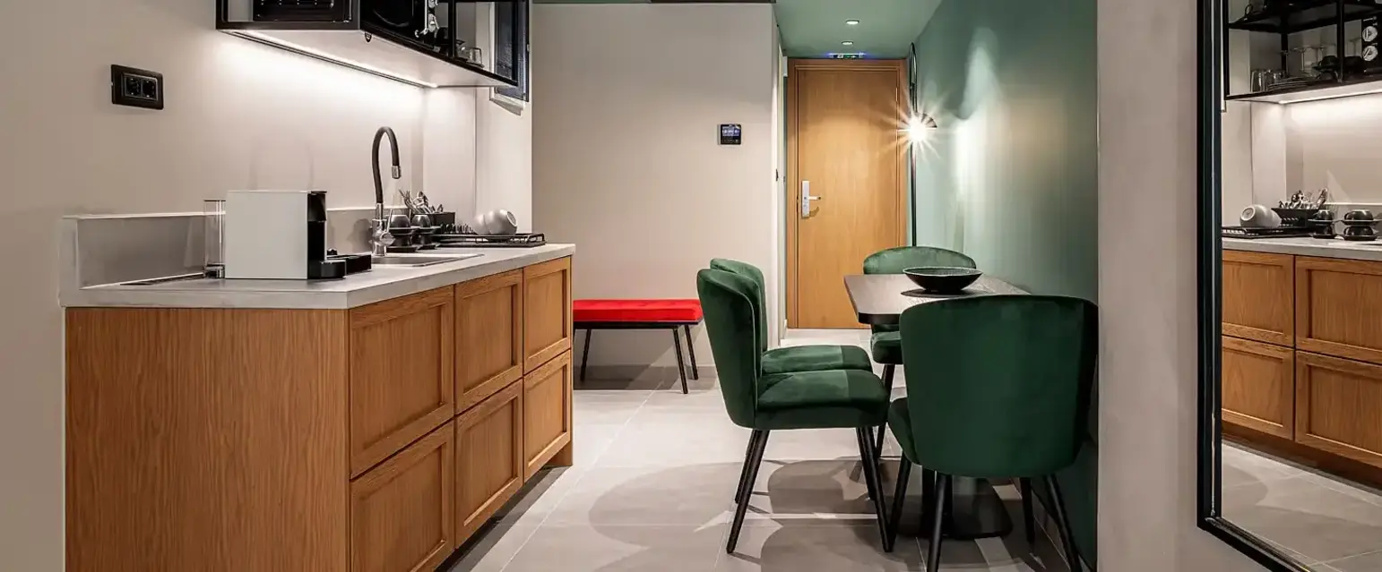 a kitchen with a table and chairs