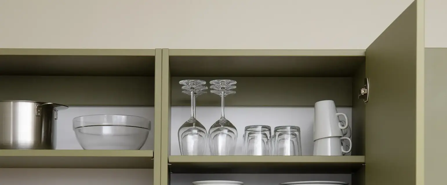 a kitchen cabinets with dishes and glasses