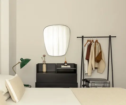 a mirror above a bed