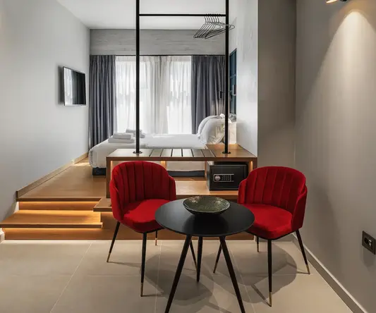 a room with a bed and a table and chairs