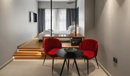 a room with a bed and a table and chairs