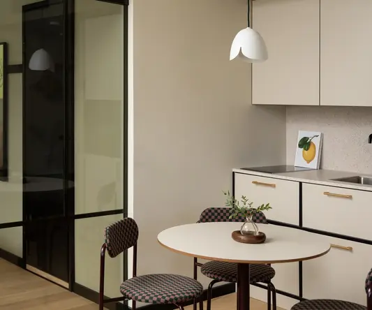 a kitchen with a table and chairs