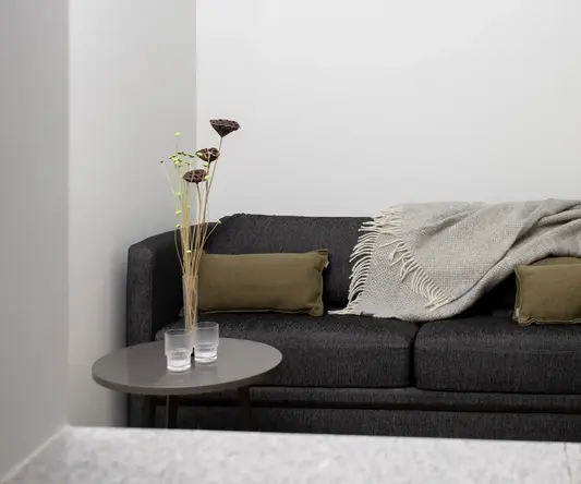 a couch with pillows and a blanket on it