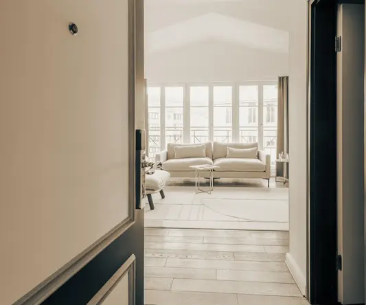 a hallway with a couch and a door