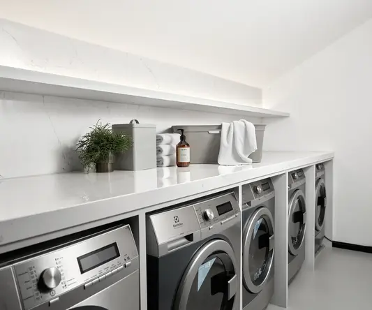 a laundry room with washing machines and a shelf