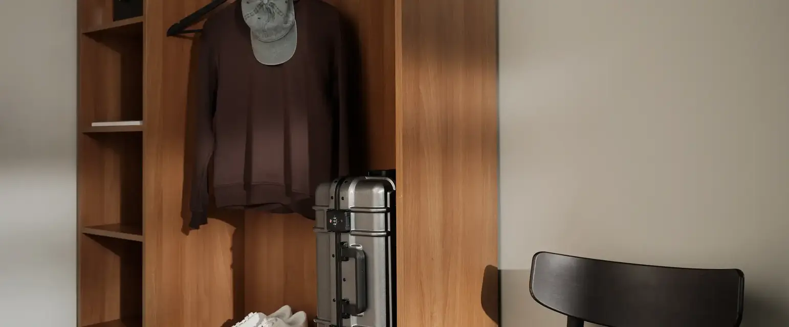 a closet with a hat and a suitcase