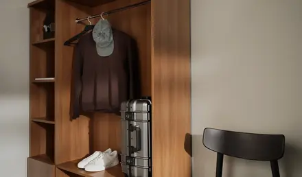 a closet with a hat and a suitcase