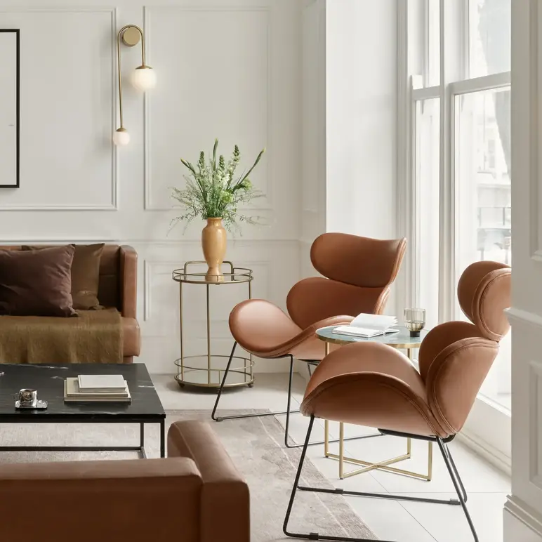 a room with a couch and chairs