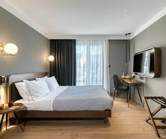 a bedroom with a bed and a tv