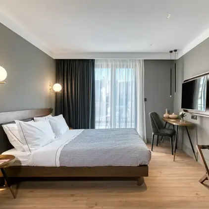 a bedroom with a bed and a tv