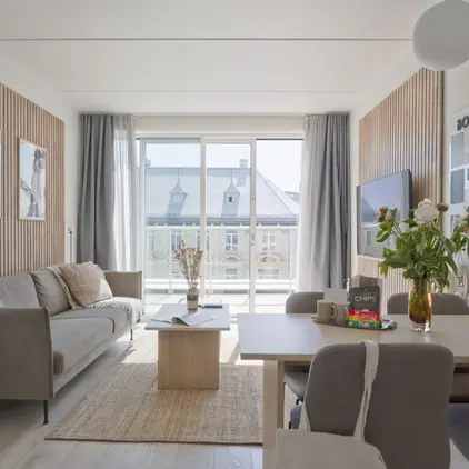 a living room with a table and chairs