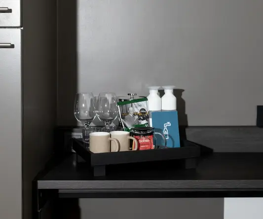 a tray of coffee cups and glasses