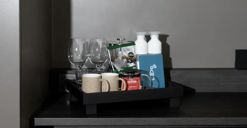 a tray of coffee cups and glasses