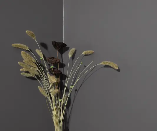 a vase with flowers and straws