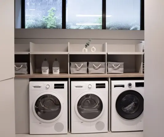 a laundry room with white appliances