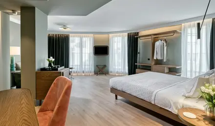 a room with a bed and a mirror