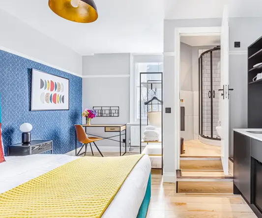 a room with a bed and a sink