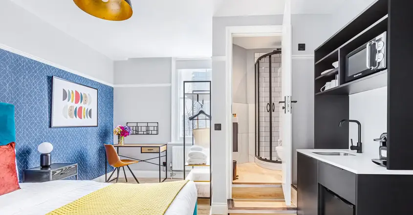 a room with a bed and a sink