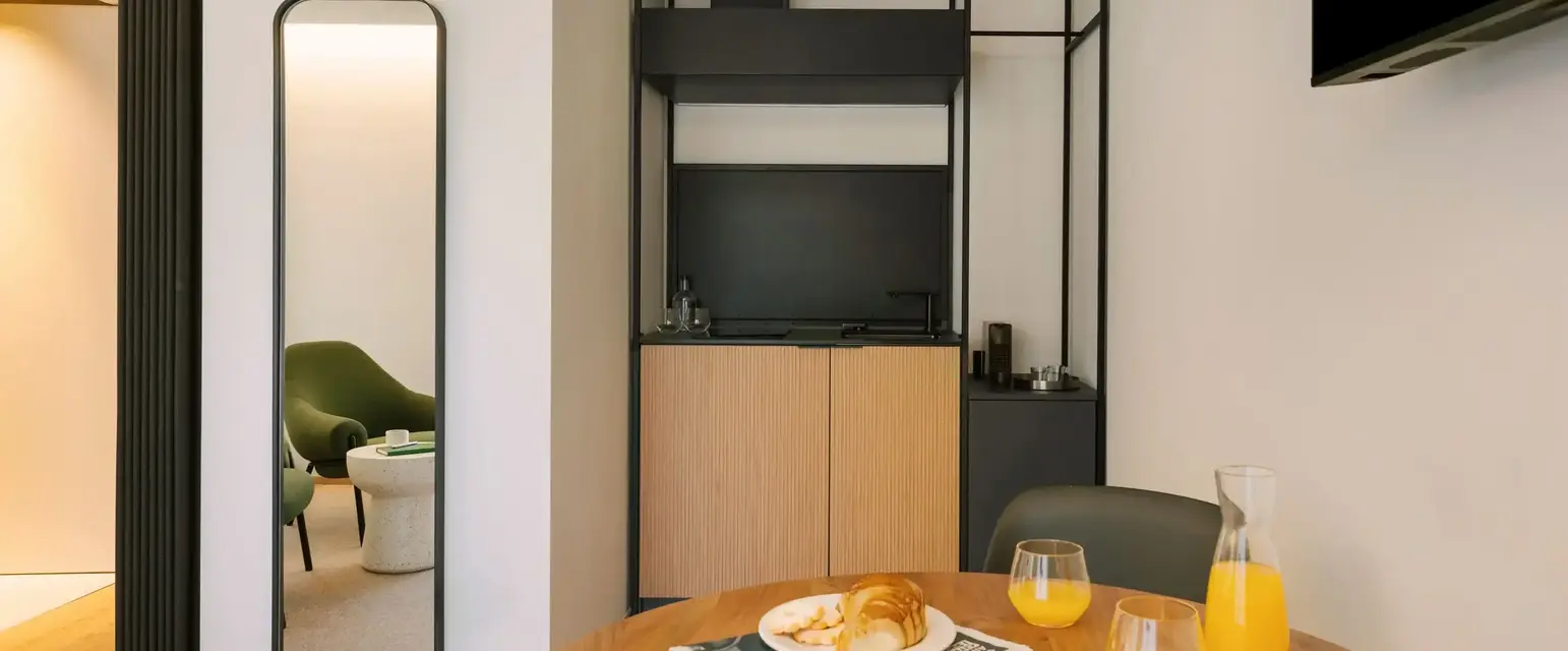 a table with a plate of food and glasses on it