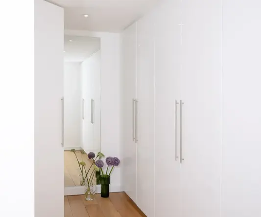 a white cabinet with flowers in it