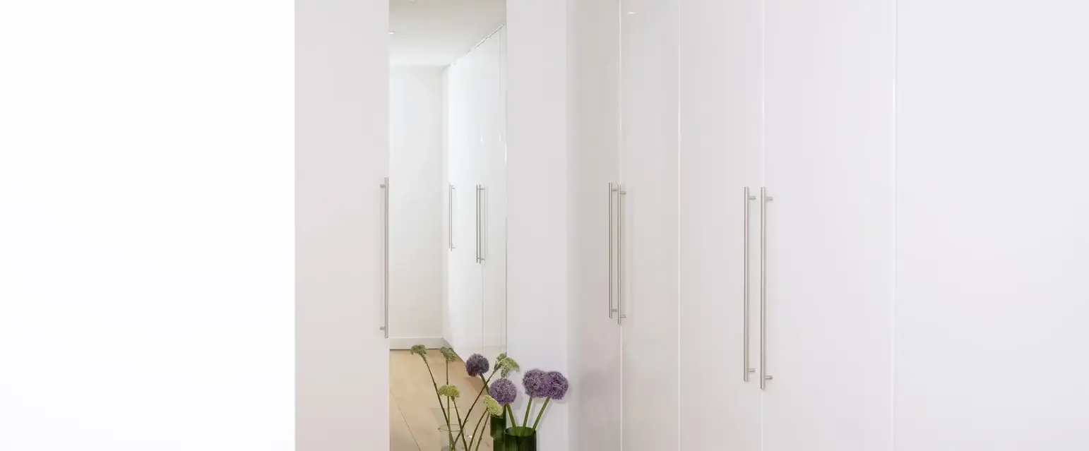 a white cabinet with flowers in it