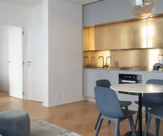 a kitchen with a round table and chairs