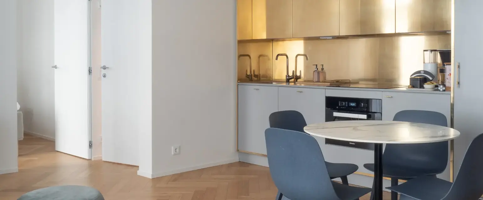 a kitchen with a round table and chairs