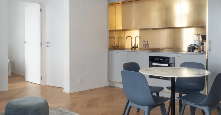 a kitchen with a round table and chairs