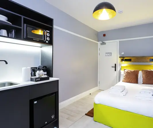 a room with a bed and a microwave