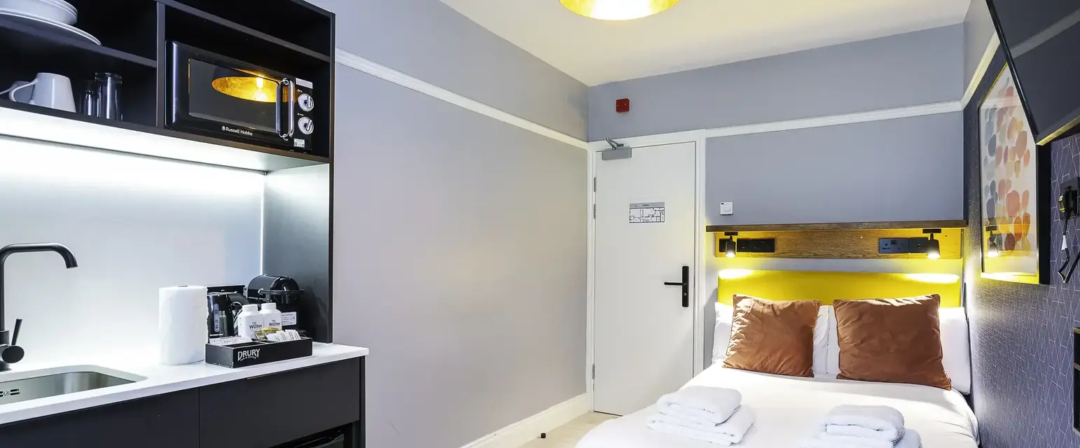 a room with a bed and a microwave
