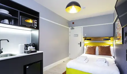 a room with a bed and a microwave
