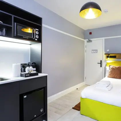 a room with a bed and a microwave