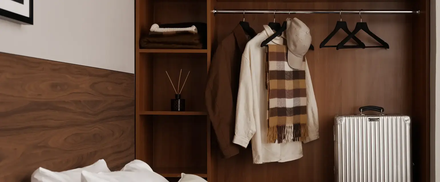 a room with a closet and a suitcase