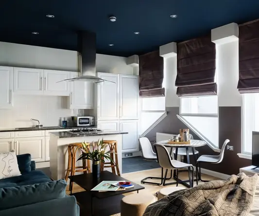 a living room with a kitchen and dining area