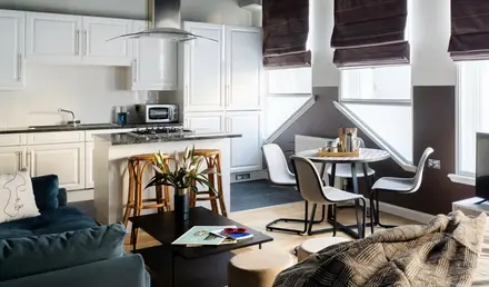 a living room with a kitchen and dining area