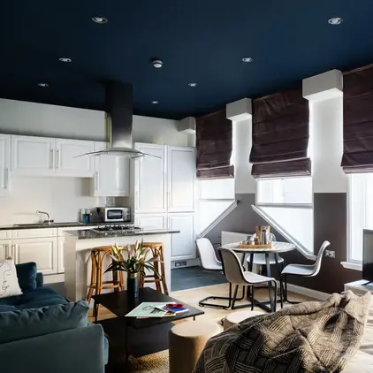 a living room with a kitchen and dining area