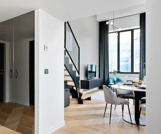 a room with a mirror door and a staircase