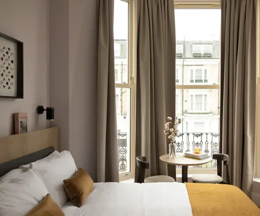 a bedroom with a bed and a table