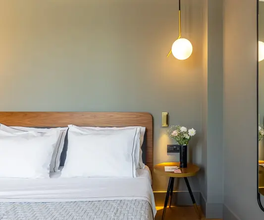 a mirror above a bed