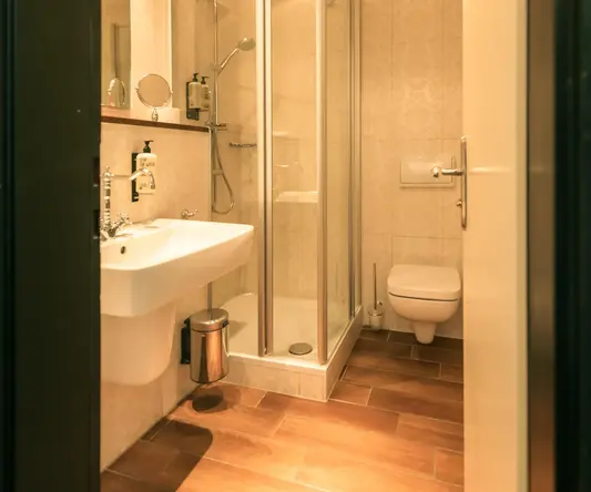 a bathroom with a glass shower and sink