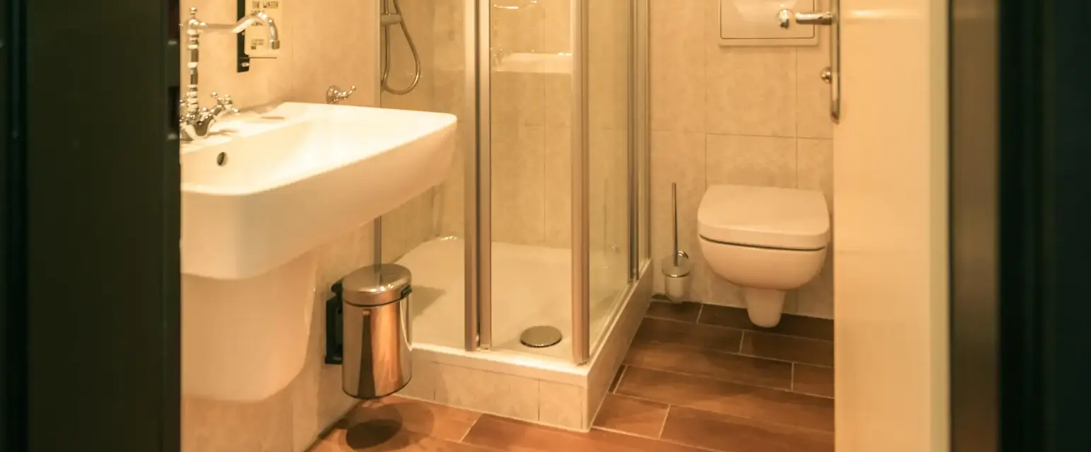 a bathroom with a glass shower and sink