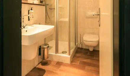 a bathroom with a glass shower and sink