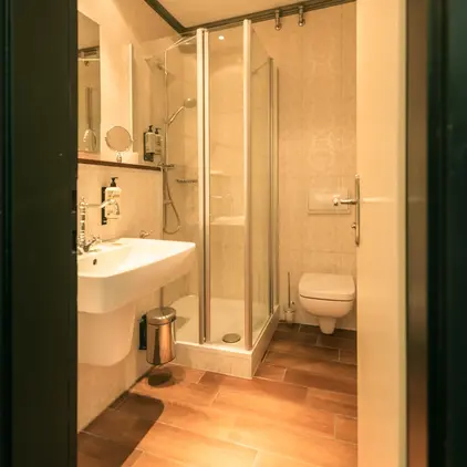 a bathroom with a glass shower and sink