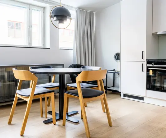 a dining table and chairs in a room