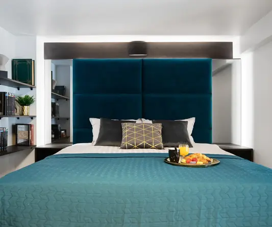 a bed with a tray of food on it