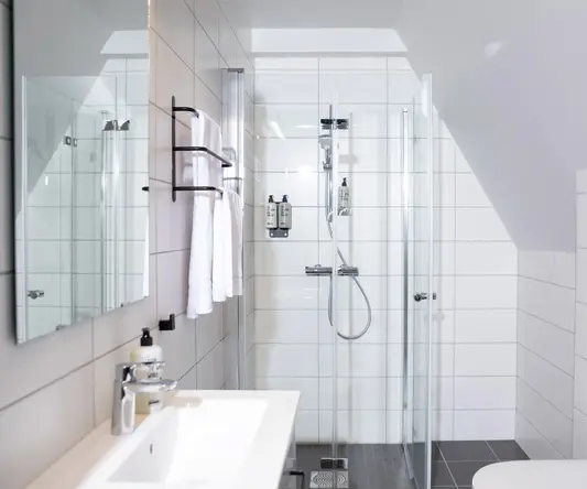 a bathroom with a shower and sink