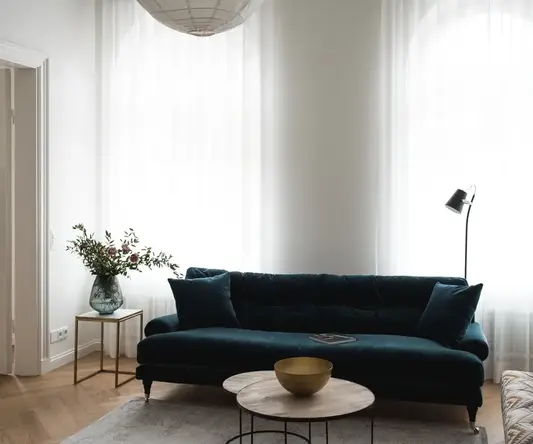a living room with a blue couch and a table
