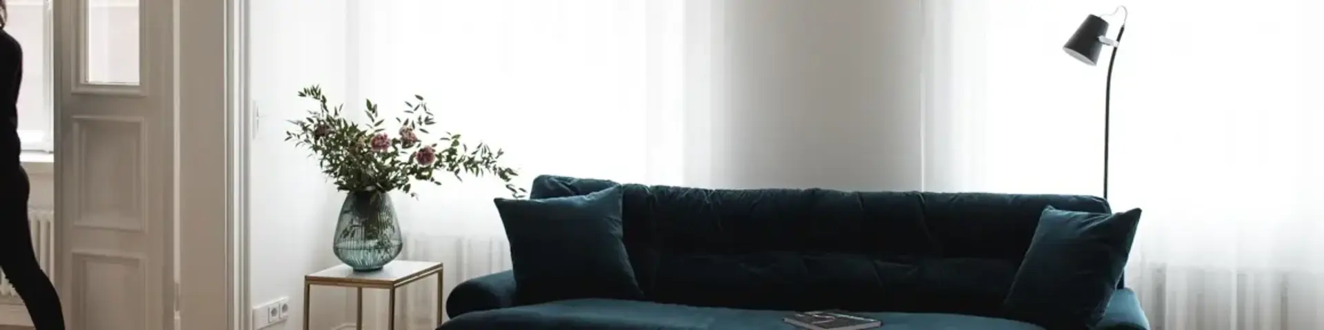 a living room with a blue couch and a table